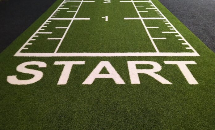 Photo by Clemens van Lay a football field with the words start written on it