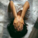 일상 속 스트레스, 똑똑하게 관리하는 건강 트렌드는? a woman holds her hands over her face